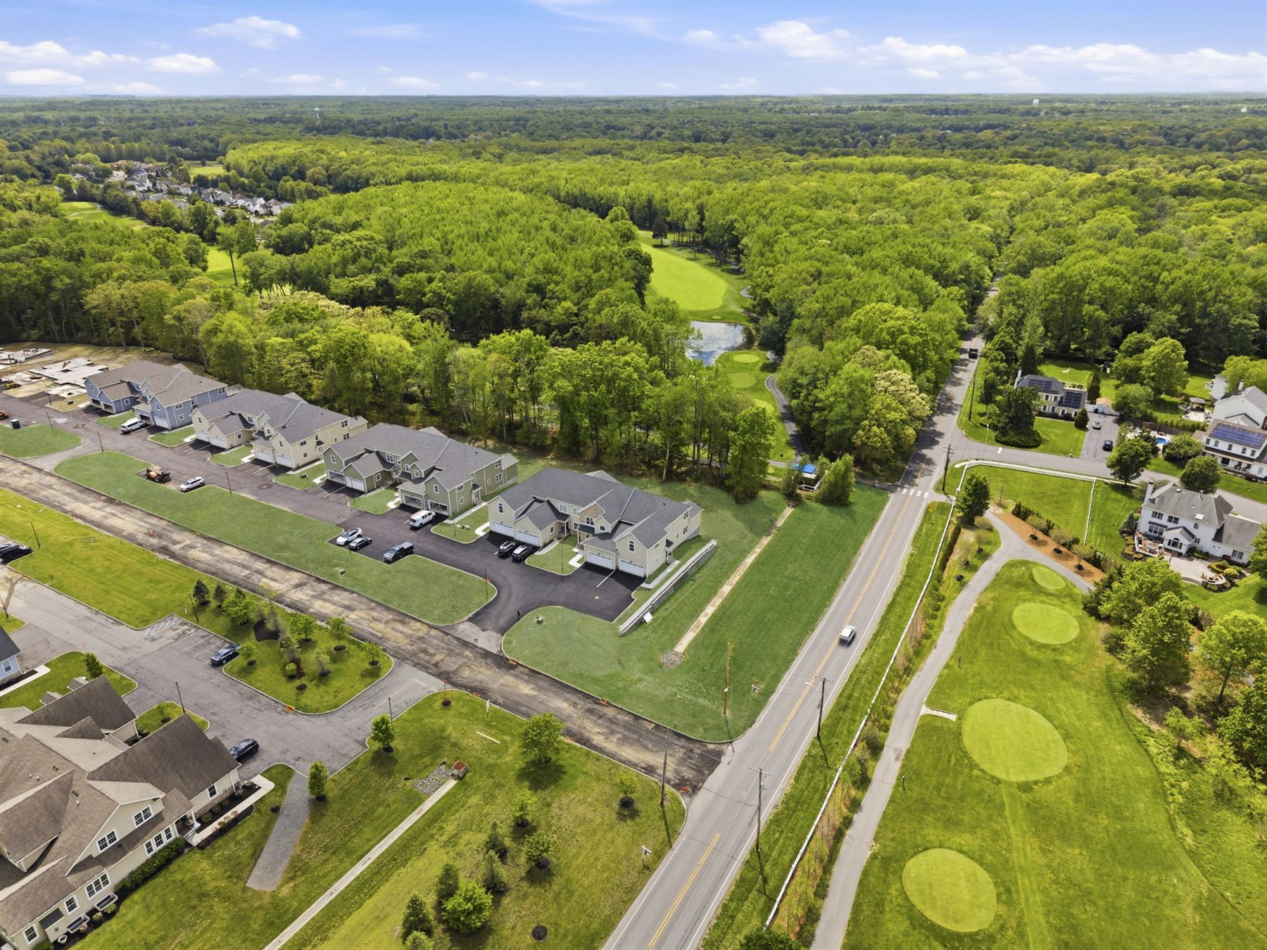 Aerial view of the townhomes with the golf course across the road
