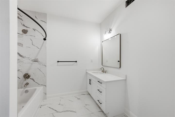Hall bath with marble-look tile