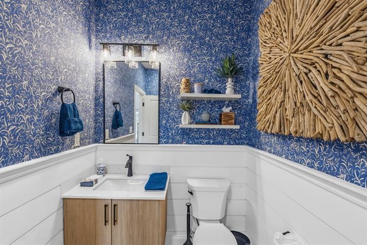 Designer powder room: Statement wallpaper above shiplap wainscoting