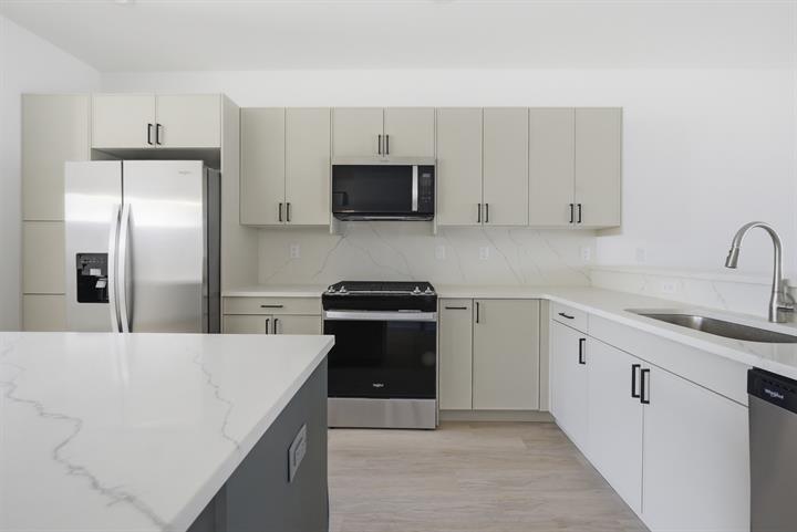 Kitchen with quartz counters and stainless appliances