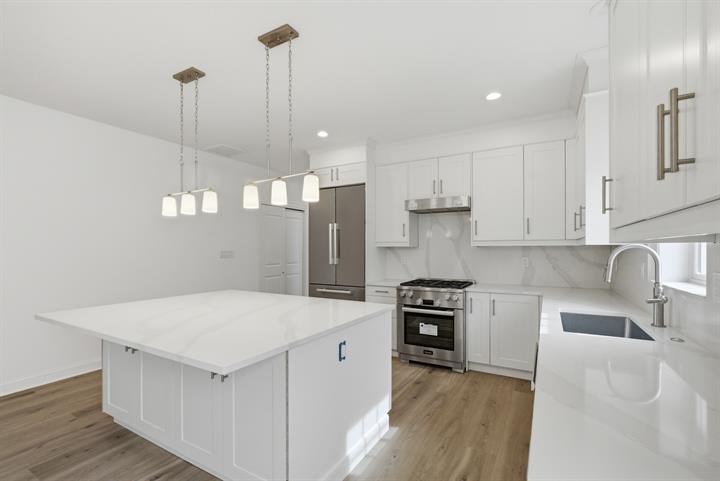 Kitchen island with pendants and a professional-style range