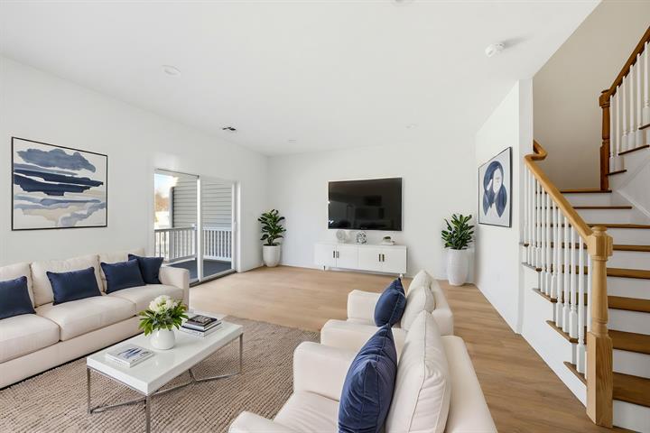 Family room with staircase, virtually staged