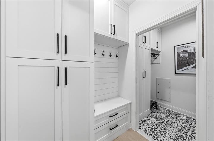 Mudroom with built-in cubbies, hooks and a bench