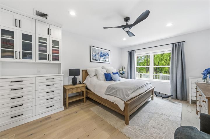 Owner's suite with built-in dressers and a ceiling fan